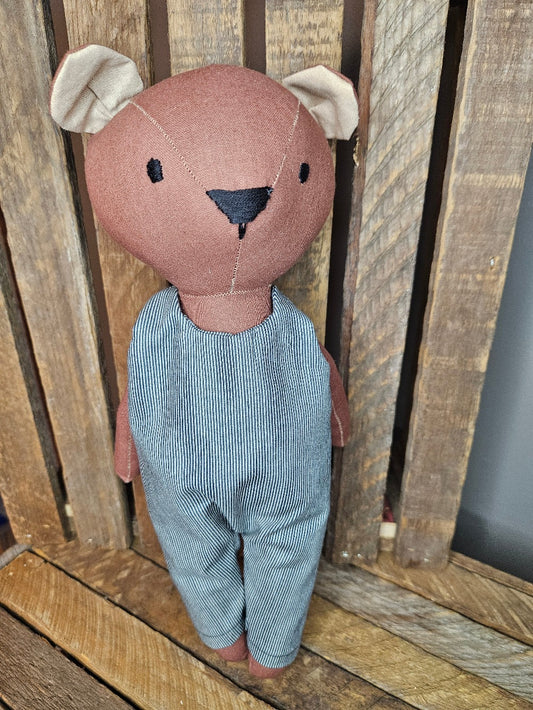 Brown bear in navy pinstripe overalls