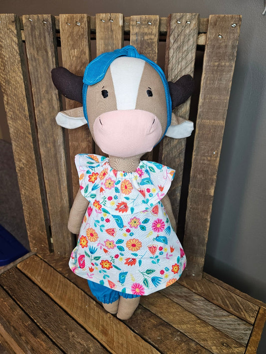 Brown Cow with floral top and blue pants