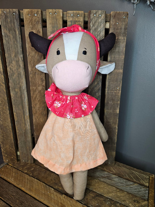 Brown cow with coral and peach dress
