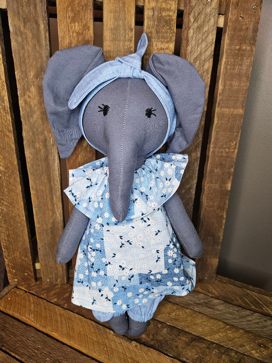 Dark gray elephant in denim blue print top and denim blue pants
