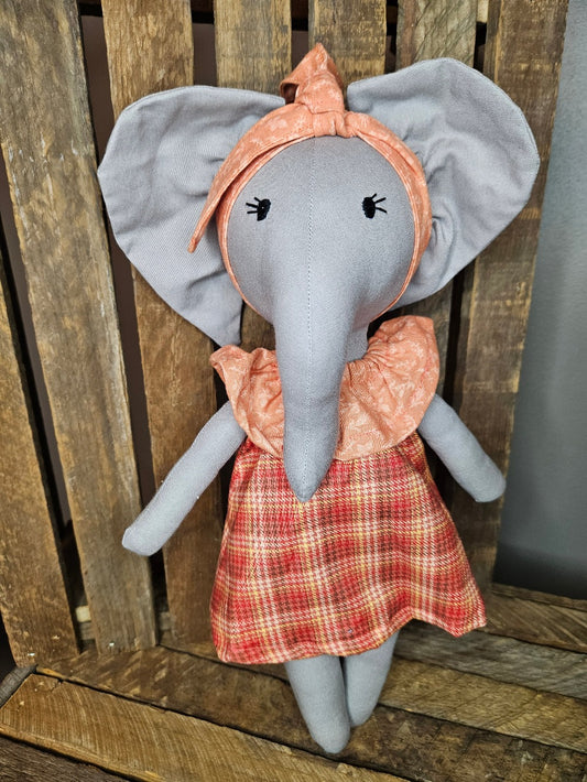 Light gray elephant with an orange plaid dress and light orange collar