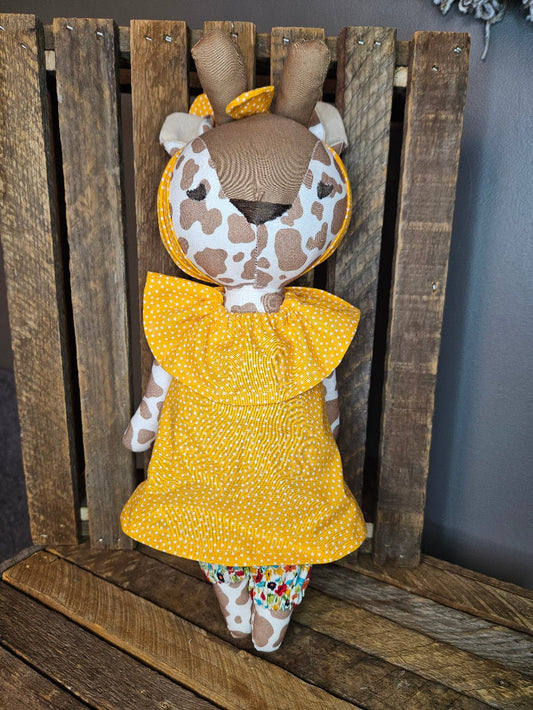 Giraffe with bright yellow top and multi-colored floral pants