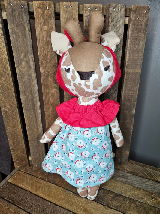 Giraffe with light teal print dress and red collar