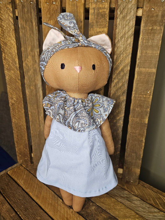 Brown kitten with light blue dress
