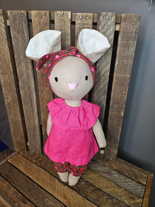 Tan mouse with bright pink top and brown print pants